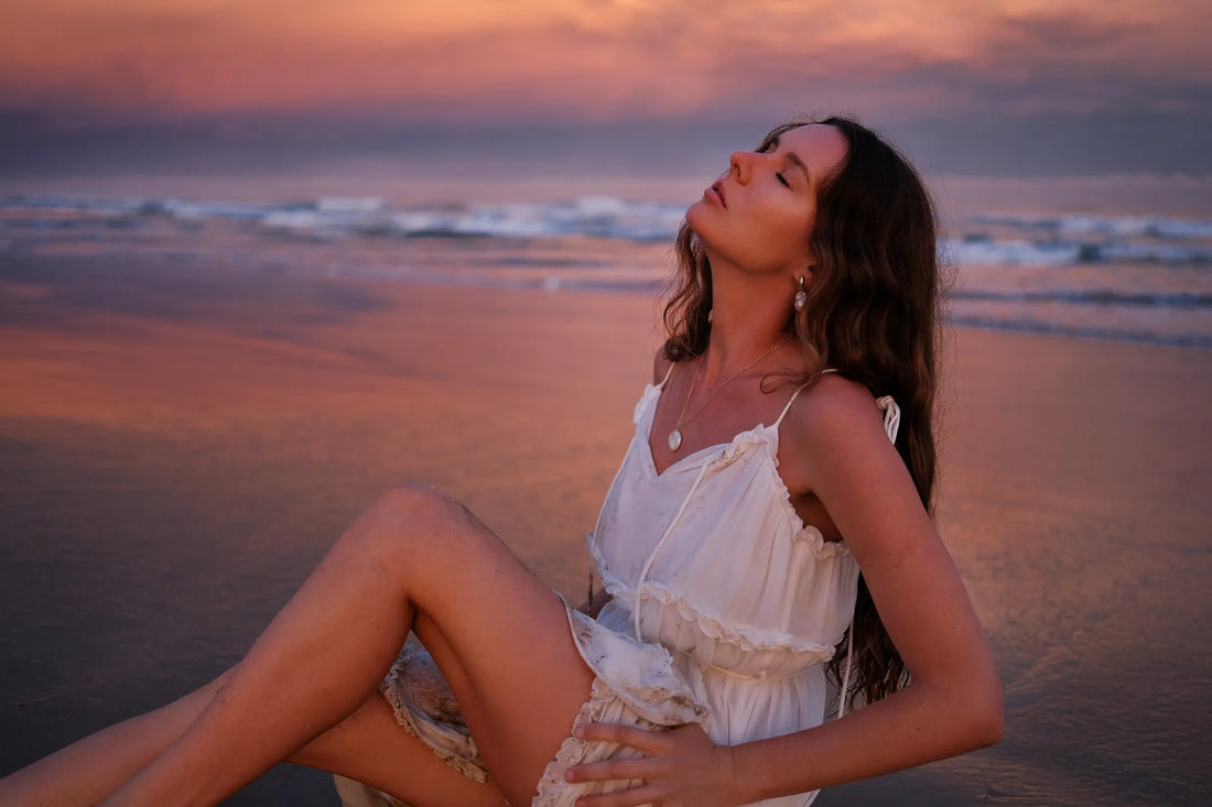 Portrait of a woman in a white dress at the beach at sunset, shot on the Fujifilm X-S20