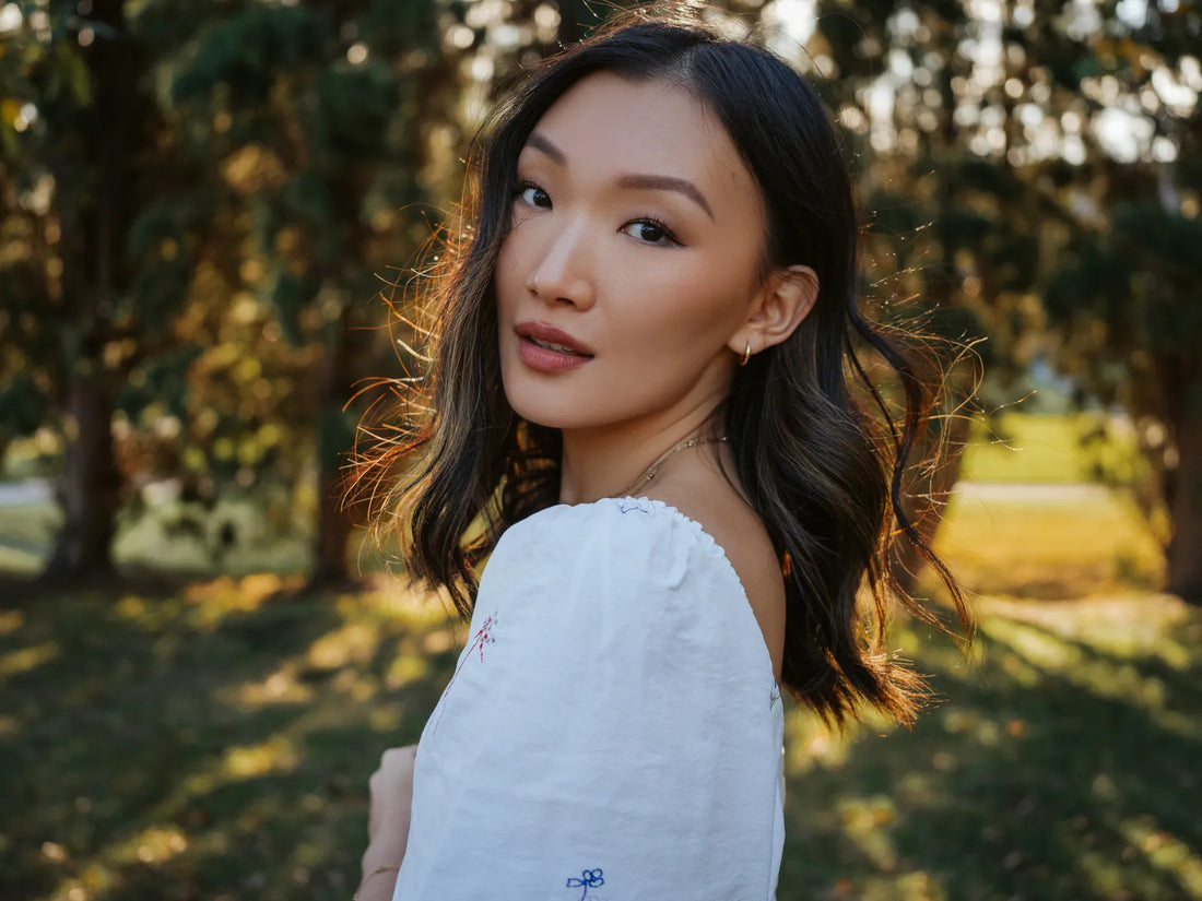 Portrait of a woman in a white dress in golden backlight, shot on the Hasselblad X2D 100C