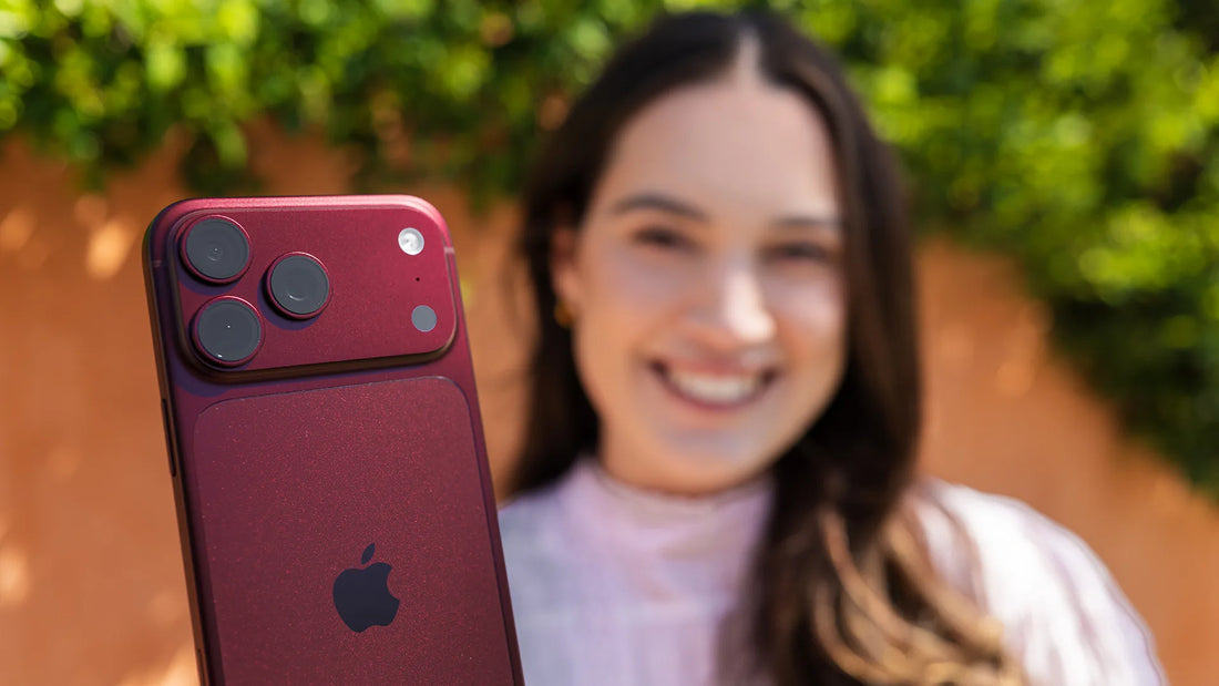 Julia Trotti holding the red iPhone 18 Pro Max, showing its triple camera