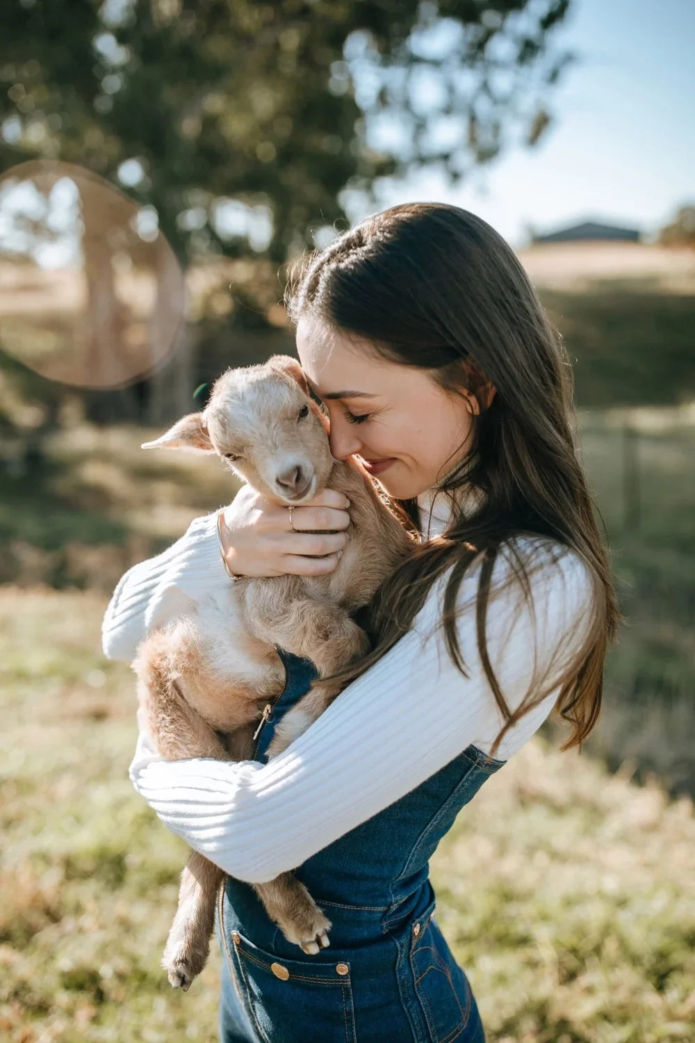 Portrait of Kristina with Ollie the baby goat, photo 1