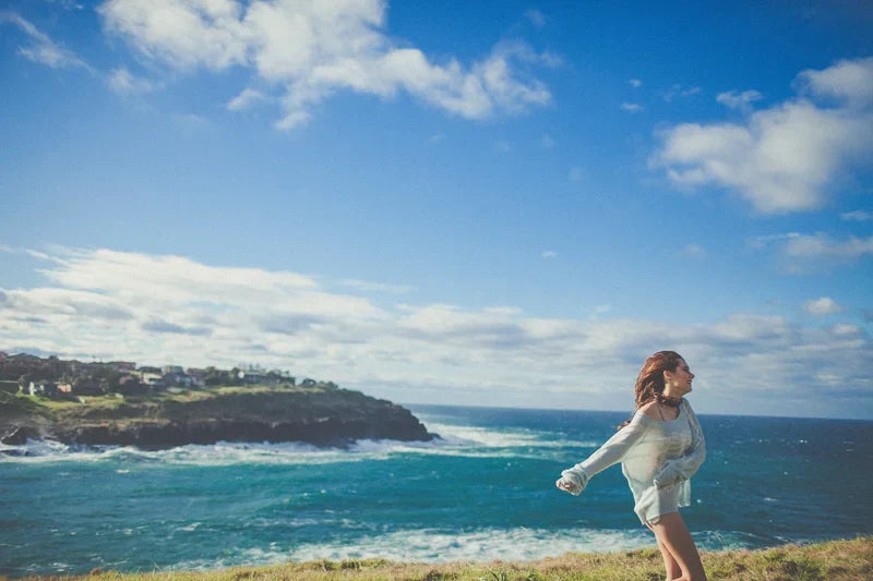 Swimsuit editorial on a cliff edge under rain clouds, photo 1