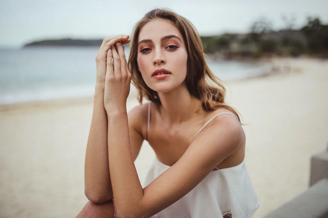 Portrait of a woman in a white top on the beach, shot on the Sigma 35mm f1.4 Art