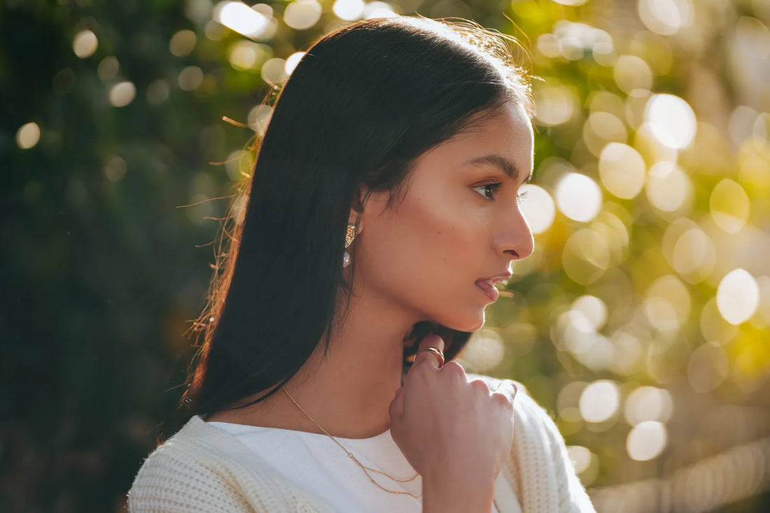 Portrait of a woman with long dark hair in golden backlight, shot on the Sony A7C II